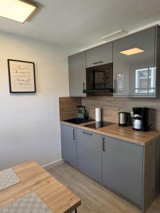 eine Küche mit weißen Schränken und einer Arbeitsplatte in der Unterkunft Schmidteinander in Norderney
