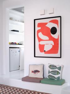 a living room with a red and white painting on the wall at Chiara Mykonos III in Mikonos