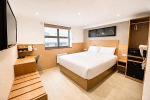 a hotel room with a bed and a television at Eurotraveller Hotel- Express (Elephant & Castle) in London