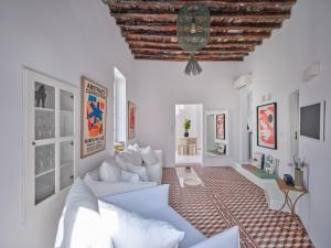 a living room with white furniture and a wooden ceiling at Chiara Mykonos III in Mikonos