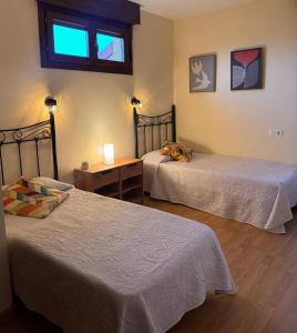 a room with two beds and a window at Casa Las Xanas in Llanes +19 photos