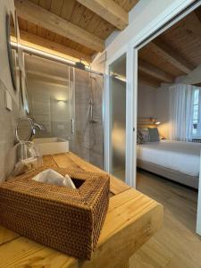 a bathroom with a table with a shower and a bed at La casa di Gio in Lezzeno +18 photos