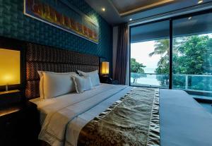 a bedroom with a large bed with a large window at Golden Pearl Tangalle Beach in Tangalle +63 photos