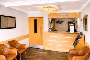 a waiting room with two chairs and a counter at Eurotraveller Hotel- Express (Elephant & Castle) in London