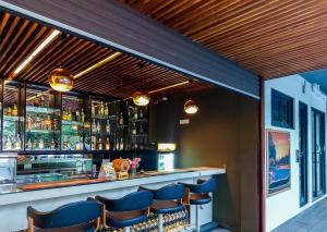 a bar with blue chairs in a restaurant at Golden Pearl Tangalle Beach in Tangalle