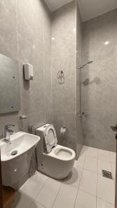 a bathroom with a toilet and a sink and a shower at شقق المشرق in Jeddah +2 photos
