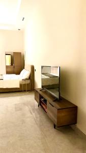 a room with a fish tank on a cabinet and a bed at شقق المشرق in Jeddah