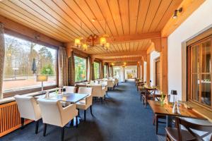 a row of tables and chairs in a restaurant at relexa hotel Schatten Stuttgart in Stuttgart