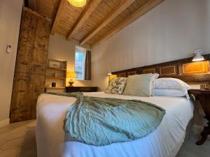 a bedroom with a large bed with a wooden headboard at Casa Melox in Lezzeno