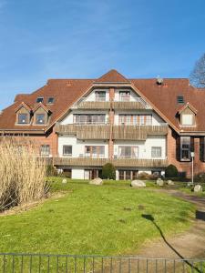 a large brick building with a yard in front of it at Landhaus am See App. 2 in Pönitz am See