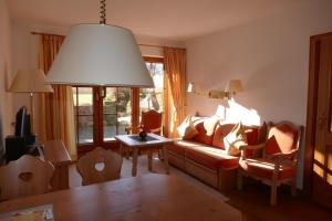a living room with a couch and a table at Landhaus am See App. 2 in Pönitz am See