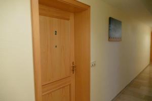 a wooden door in a room with a hallway at Landhaus am See App. 2 in Pönitz am See