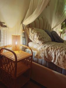 a bedroom with a bed and a table with a lamp at Angel's Home in Dunajská Streda