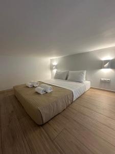 a bedroom with a bed with two towels on it at Modern Lofts in Archangelos Rhodes with Parking - Equus - 3 Guests in Archangelos