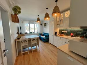 a kitchen and living room with a blue couch at Angel's Home in Dunajská Streda