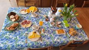 a blue and white table with breakfast foods on it at Au Grand Babin - Namur in Namur