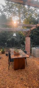 a wooden table sitting under a pergola at GARDEN House in Ban Phru Ching (1)