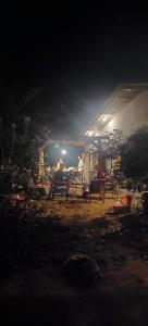 a group of people sitting in chairs under a tent at night at GARDEN House in Ban Phru Ching (1)