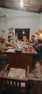 a group of people sitting around a wooden table at GARDEN House in Ban Phru Ching (1)
