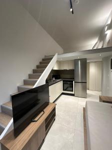 a kitchen with a staircase and a living room at Modern Lofts in Archangelos Rhodes with Parking - Equus - 3 Guests in Archangelos