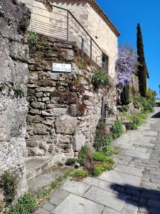 an old stone building with a street sign on it at Logement 2 cité de caractère in Mallièvre