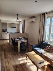 a living room with a couch and a table at Logement 2 cité de caractère in Mallièvre