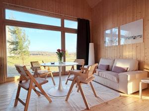 ein Wohnzimmer mit Sofa, Tisch und Stühlen in der Unterkunft Slowcabin in Retowo