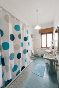 a bathroom with a sink and a shower curtain at Casa Dalì in Pianillo +57 photos