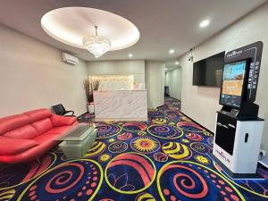 a room with a couch and a flat screen tv at Love Inn Hotel Kuchai Lama in Kuala Lumpur +16 photos
