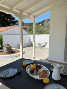 a black table with a plate of food on it at Ninemo Residences Skiathos in Achladies