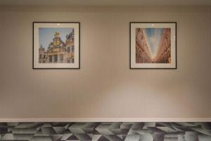 two framed pictures on a wall in a room at Eurostars Avenue Louise in Brussels +28 photos
