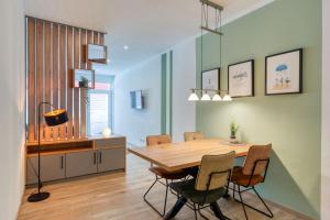 a dining room with a wooden table and chairs at Alte Teestube Schmidt 59 Links in Norderney