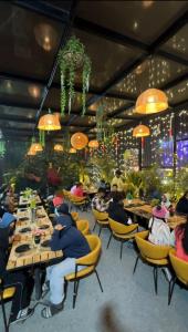 a group of people sitting at tables in a restaurant at HOTEL SIYARAM Inn in Jāmb