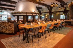 a row of tables and chairs in a restaurant at Ahrenshof 7 in Bad Zwischenahn