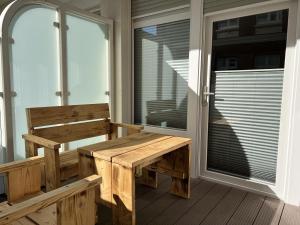 a bench on the porch of a house at Alte Teestube Schmidt 58 in Norderney