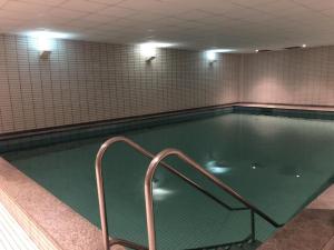 an empty swimming pool with a handrail in a building at Alte Teestube 55 in Norderney
