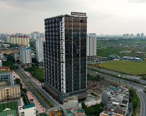 a tall building with a sign on it in a city at Westlake view Duplex Studio in Hanoi