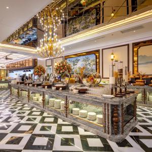 a buffet in a hotel lobby with a chandelier at Imperial Dalat Hotel, BW Premier Collection in Da Lat
