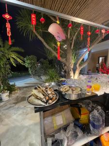 a buffet with plates of food on a table at Sun Homestay Doclet in Doc Let