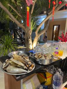 a buffet with two trays of food on a table at Sun Homestay Doclet in Doc Let +83 photos