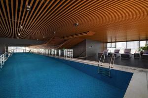 a swimming pool in a building with chairs and a swimming pool at Westlake view Duplex Studio in Hanoi