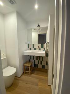 a white bathroom with a sink and a toilet at Hotelet Bastio 12 in Ciutadella +45 photos