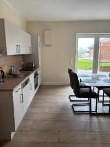 a kitchen and dining room with a table and chairs at Ferienwohnung Arendsee in Arendsee +24 photos