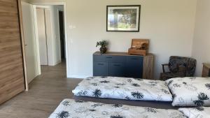 a living room with a bed and a chair at Ferienwohnung Arendsee in Arendsee
