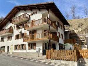 a building with wooden balconies on the side of it at Appartamento Il Conte di Avoscano in Piaia