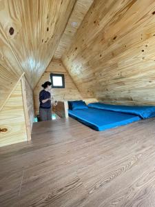 a man is standing in a tiny house at Homestay Gió Mộc !!! in Làng Môn