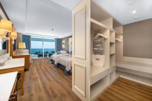 a bedroom with a bed and a desk and a desk at Sueno Hotels Deluxe Belek in Belek +66 photos