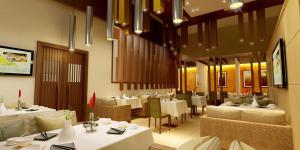 a restaurant with white tables and white chairs and tablesearcher at Pearltree Hotels And Resorts in Purulia