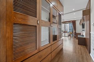 a hallway with wood paneling and wooden doors at AVA Hotel & Apartment in Danang