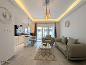 a living room with two couches and a table at Chic apart with parking and balcony in Yaoundé